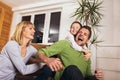 Family having fun on floor of in living room at home, laughing