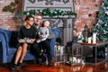 Happy family having fun at home. In loft room with brick wall. Young parents with little son. father, mother and their Royalty Free Stock Photo