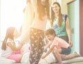 Happy family having fun inside hotel bed room on summer vacation - Parents and children making pillows fight together - Travel ,