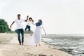 Happy family having fun at muddy beach located in pantai remis