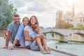 Happy family having fun near Notre-Dame cathedral in Paris. Tourists enjoying their vacation in France. Royalty Free Stock Photo