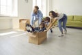 Happy young parents and children playing with cardboard boxes in their new apartment Royalty Free Stock Photo