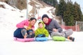 Happy family having fun outdoors, Asian mother father and cute little 3 years old toddler boy son playing in snow Royalty Free Stock Photo