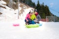 Happy family having fun outdoors, Asian mother father and cute little 3 years old toddler boy son playing in snow Royalty Free Stock Photo