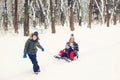 Happy family having fun in snowy park. Children and mother playing in winter time. Active healthy lifestyle. Winter christmas Royalty Free Stock Photo