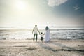 Happy family having fun time together at the beach having nice sunset view located in Pantai Remis