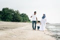 Happy family having fun time walking together at the beach located in Pantai Remis Royalty Free Stock Photo