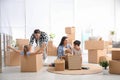 Happy family having fun while unpacking moving boxes at new home Royalty Free Stock Photo