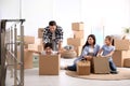 Happy family having fun while unpacking moving boxes at their home Royalty Free Stock Photo