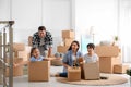 Happy family having fun while unpacking moving boxes at their home Royalty Free Stock Photo