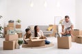 Happy family having fun while moving boxes at their new home Royalty Free Stock Photo