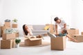 Happy family having fun while unpacking moving boxes Royalty Free Stock Photo