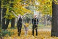 Happy family having holiday in autumn city park. Children and parents posing, smiling, playing and having fun Royalty Free Stock Photo