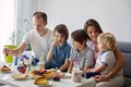 Happy family, having pancakes for breakfast, eating in living room, talking and laughing Royalty Free Stock Photo