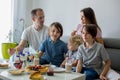Happy family, having pancakes for breakfast, eating in living room, talking and laughing Royalty Free Stock Photo