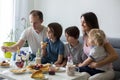 Happy family, having pancakes for breakfast, eating in living room, talking and laughing Royalty Free Stock Photo