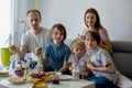 Happy family, having pancakes for breakfast, eating in living room, talking and laughing Royalty Free Stock Photo