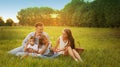 Happy family having picnic and blowing soap bubbles in park Royalty Free Stock Photo