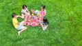 Happy family having picnic in park, parents with kids sitting on grass and eating healthy meals outdoors Royalty Free Stock Photo