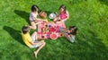 Happy family having picnic in park, parents with kids sitting on grass and eating healthy meals outdoors Royalty Free Stock Photo