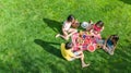 Happy family having picnic in park, parents with kids sitting on grass and eating healthy meals outdoors Royalty Free Stock Photo