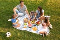 Happy family having picnic in park on summer day Royalty Free Stock Photo