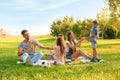 Happy family having picnic in park on summer day Royalty Free Stock Photo