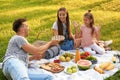 Happy family having picnic in park on summer day Royalty Free Stock Photo