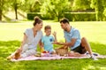 Happy family having picnic at summer park Royalty Free Stock Photo