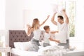 Happy family having pillow fight on bed Royalty Free Stock Photo