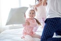 Happy family having pillow fight in bed at home Royalty Free Stock Photo