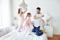 Happy family having pillow fight in bed at home Royalty Free Stock Photo