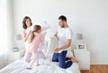 Happy family having pillow fight in bed at home Royalty Free Stock Photo