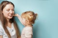 Happy family and health. mother and daughter child girl brushing their teeth together on blue background Royalty Free Stock Photo