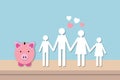 Happy family with heart and pink piggybank on table and blue background. Concept for family finance plan. Royalty Free Stock Photo