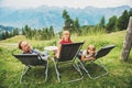 Happy family hiking in swiss Alps, enjoying amazing view, travel with kids