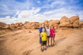 Happy family hiking together in the beautiful rock formations of Arches National Park Royalty Free Stock Photo