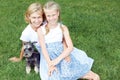 Happy family with his dog sitting on green grass and read e-book. Horizontal photo Royalty Free Stock Photo