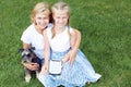 Happy family with his dog sitting on green grass and read e-book. Horizontal photo Royalty Free Stock Photo