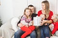 Happy family holding christmas gifts at home Royalty Free Stock Photo