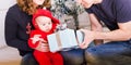 Happy family holding Christmas gifts near Xmas tree. Baby, mother and father having fun at home Royalty Free Stock Photo