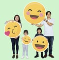 Happy family holding emoji icons