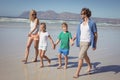 Happy family holding hands while walking at beach Royalty Free Stock Photo