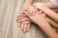 Happy family holding hands at wooden table, closeup Royalty Free Stock Photo