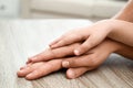 Happy family holding hands at wooden table indoors Royalty Free Stock Photo