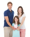 Happy Family Holding Piggy Bank Together