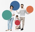 Happy family holding round colorful boards