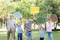 Happy family holding up speech bubbles Royalty Free Stock Photo