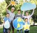 Happy family holding up weather icons