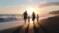 Happy family holidays. Joyful father, mother, baby son walk with fun along edge of sunset sea surf on black sand beach. Active